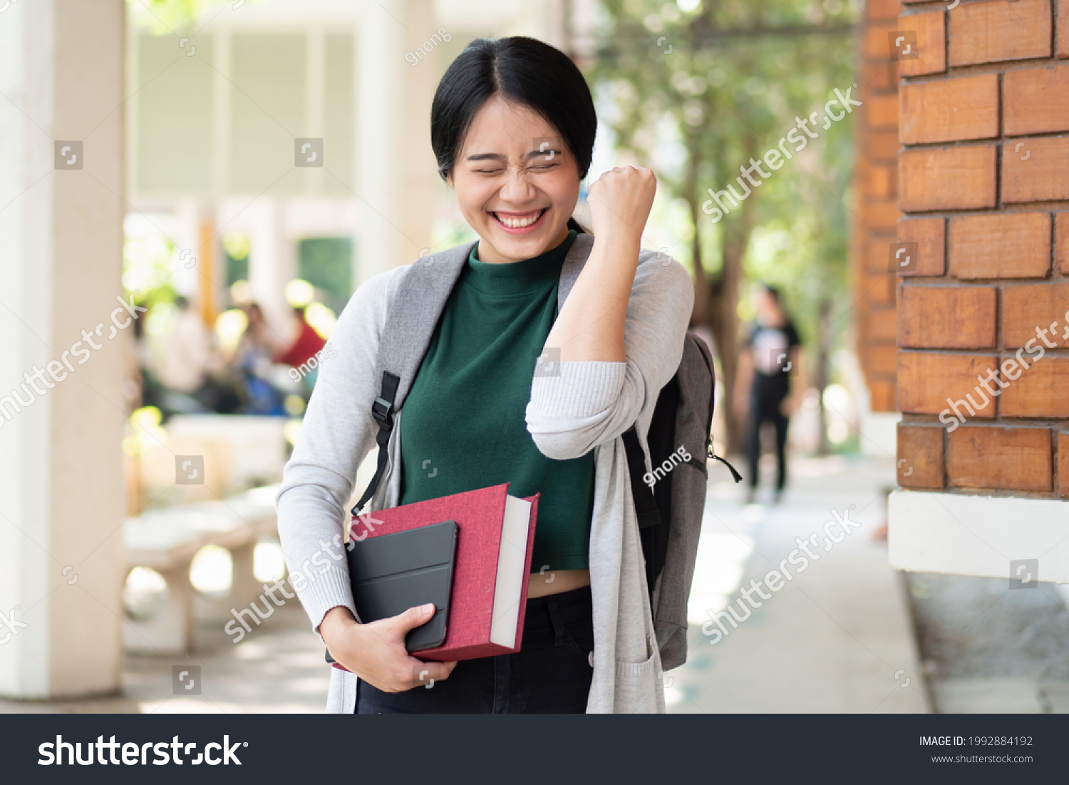 Excitted and confident asian woman college student getting back to school after reopening and vaccination rollout program