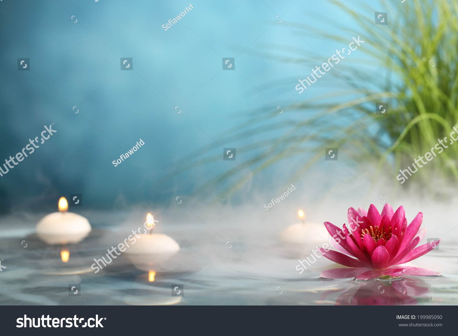 Burning candles and water lily in a serenity pool