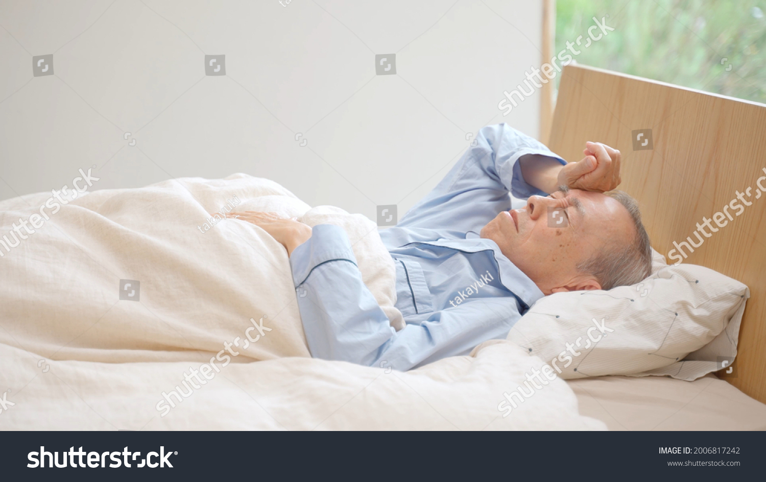 senior asian man sleeping on the bed