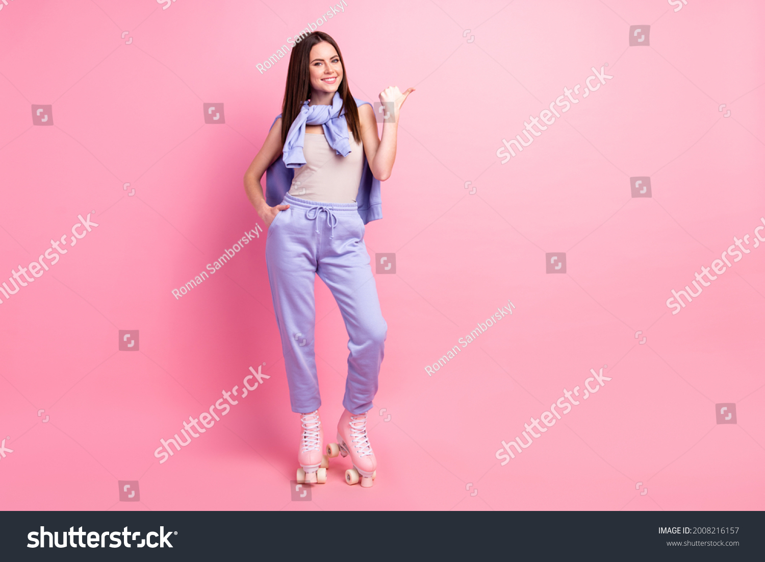 Full body photo of young girl happy smile ride roller skates point thumb empty space ad advice isolated over pastel color background