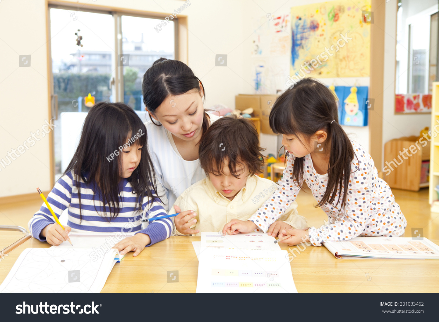 Nursery and three children educating intellectual drilling