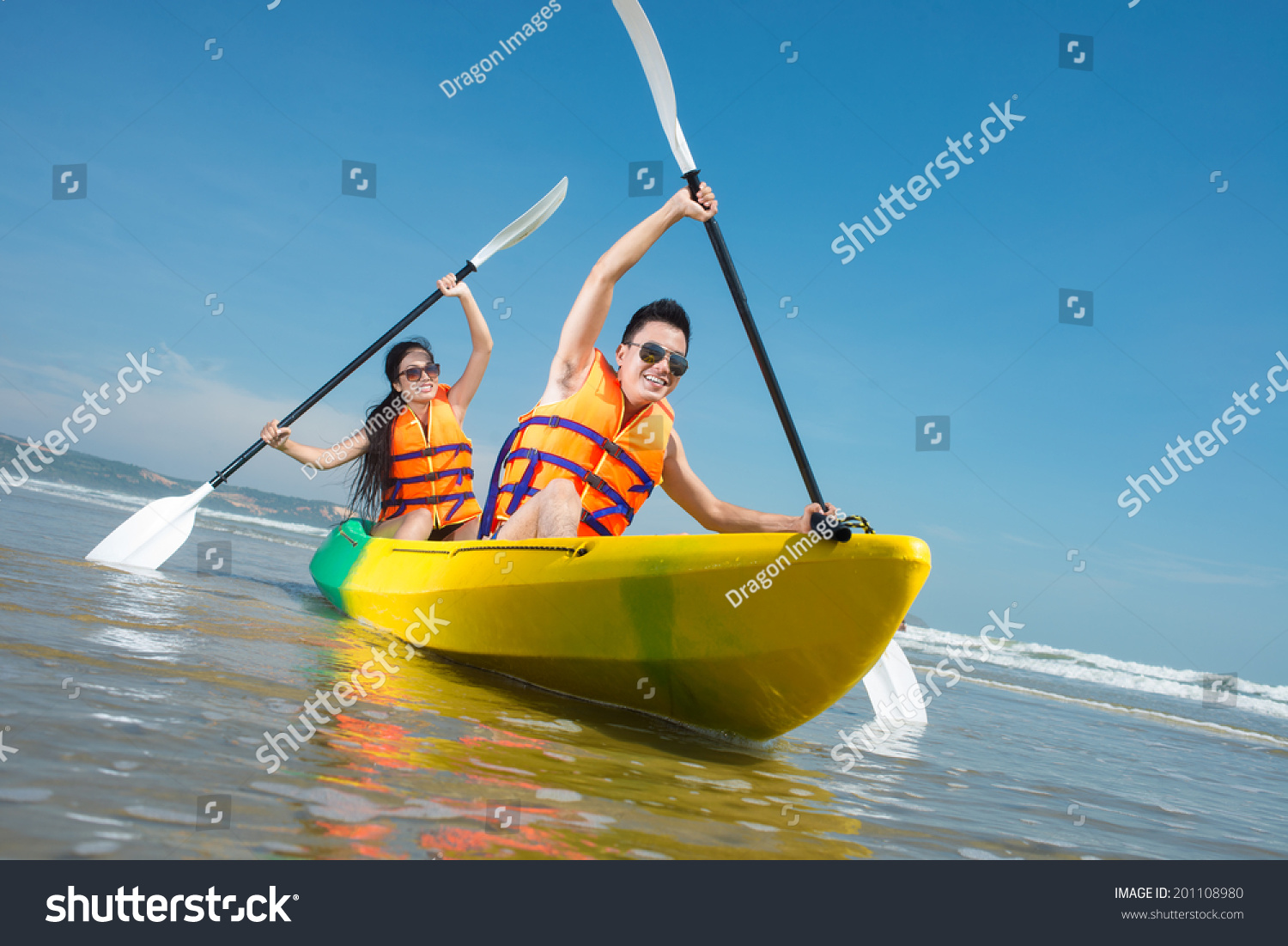 Cheerful couple paddling in kayak