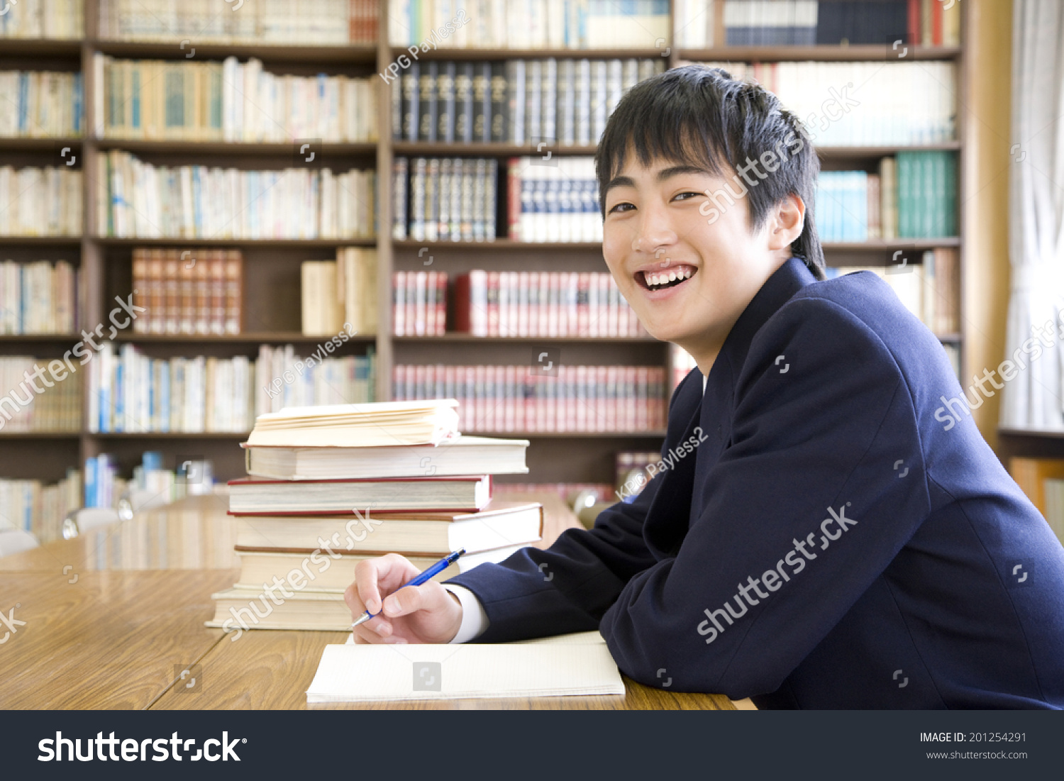 A middle school boy studying in a library