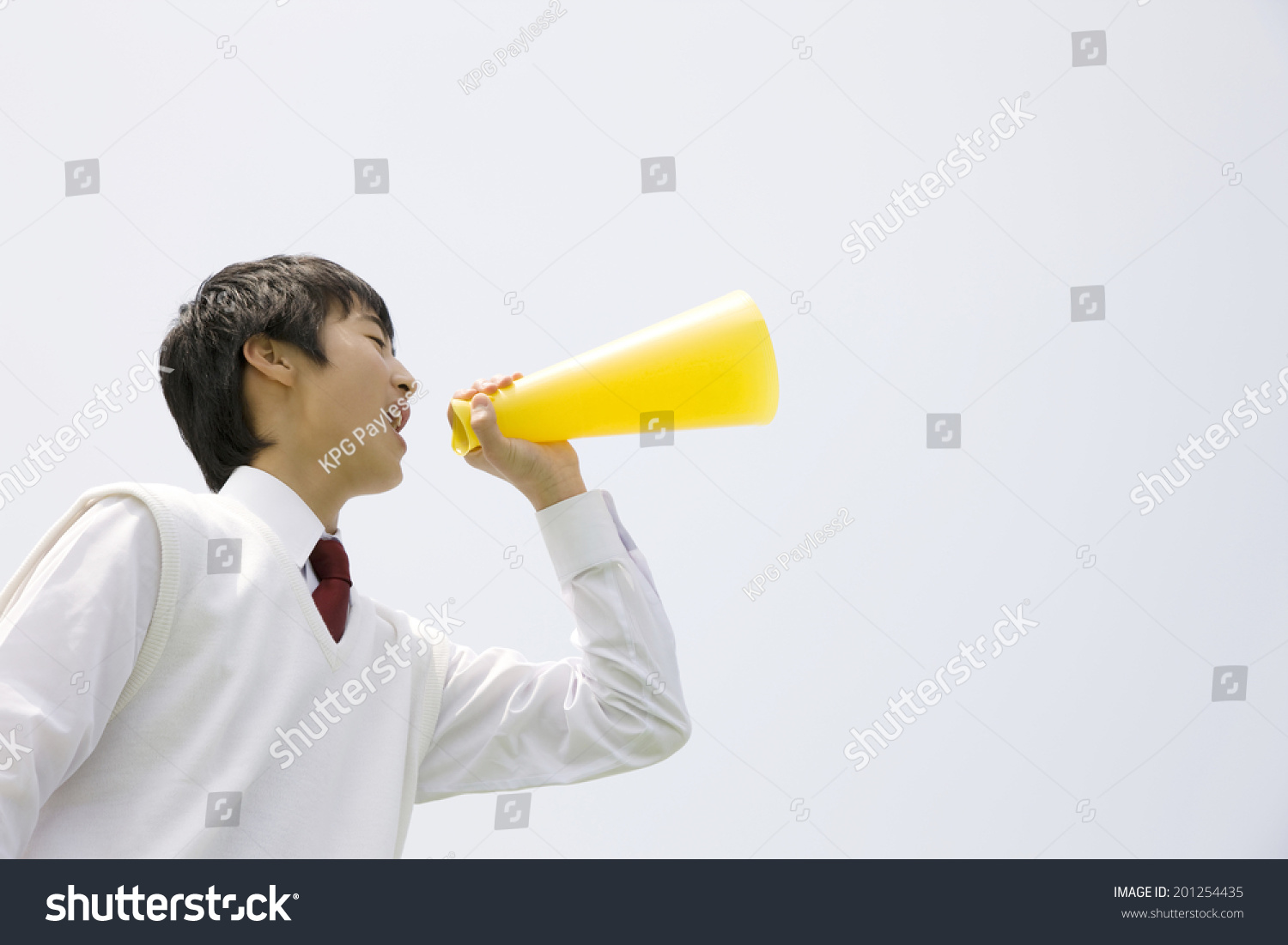 A middle school boy screaming through a megaphone
