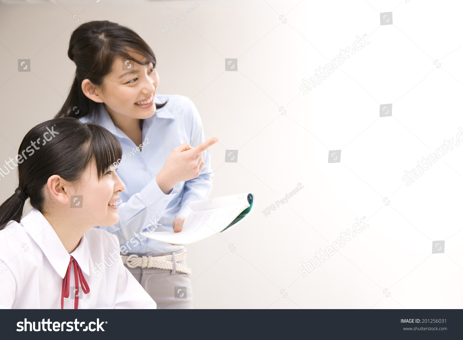 A middle school girl learning from a teacher at an institute
