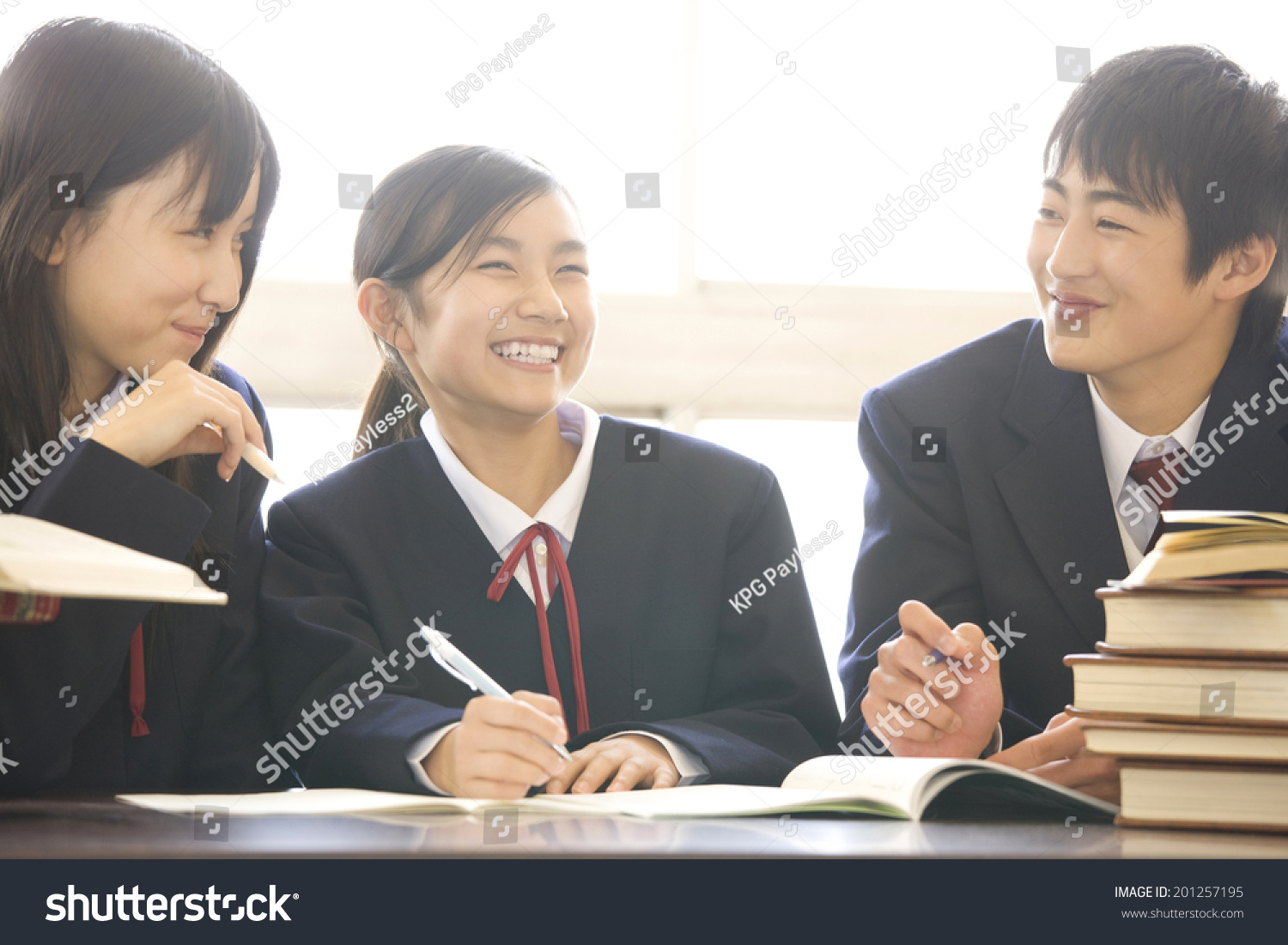 Middle school boys and girls studying in a library