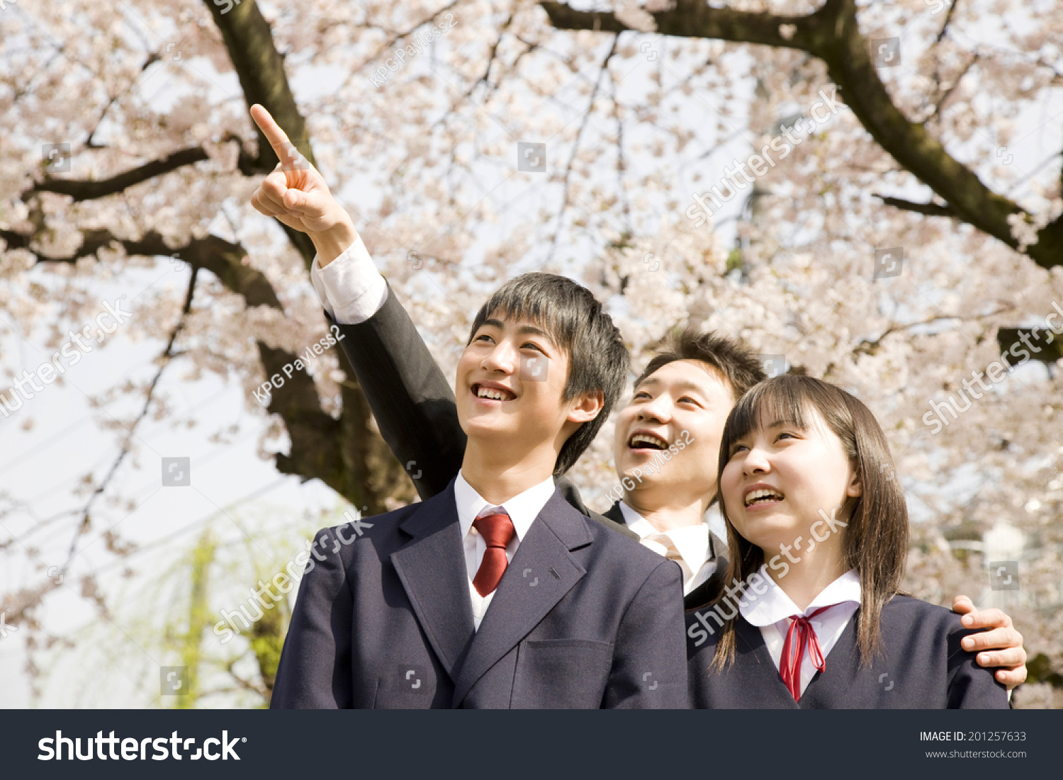 A teacher and middle school boys and girls looking up to the sky