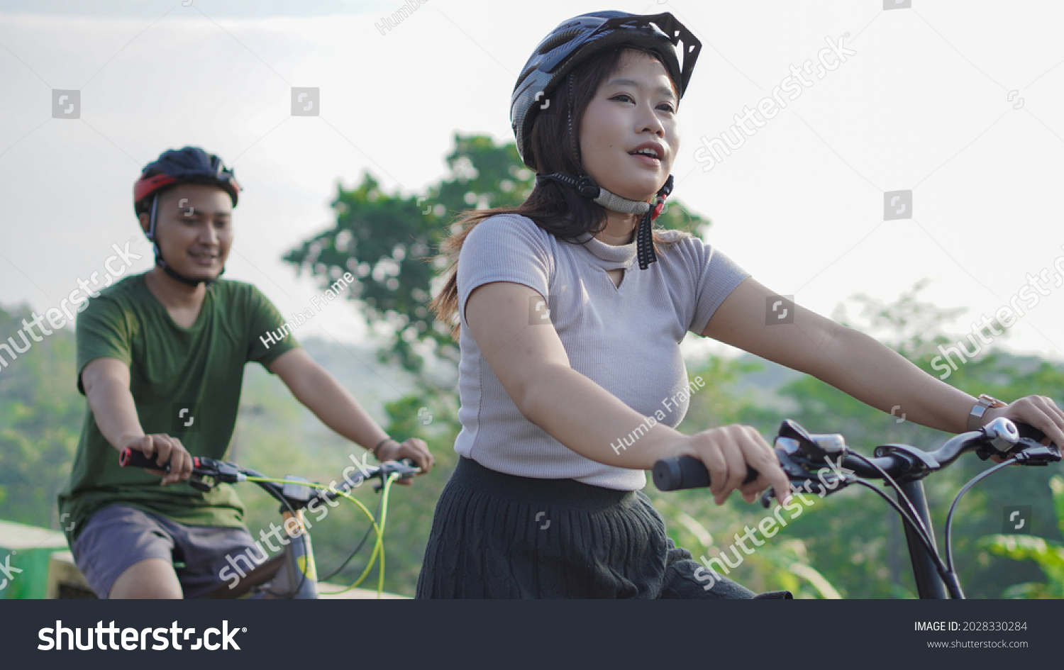 young asian couple ride bicycle together in the morning