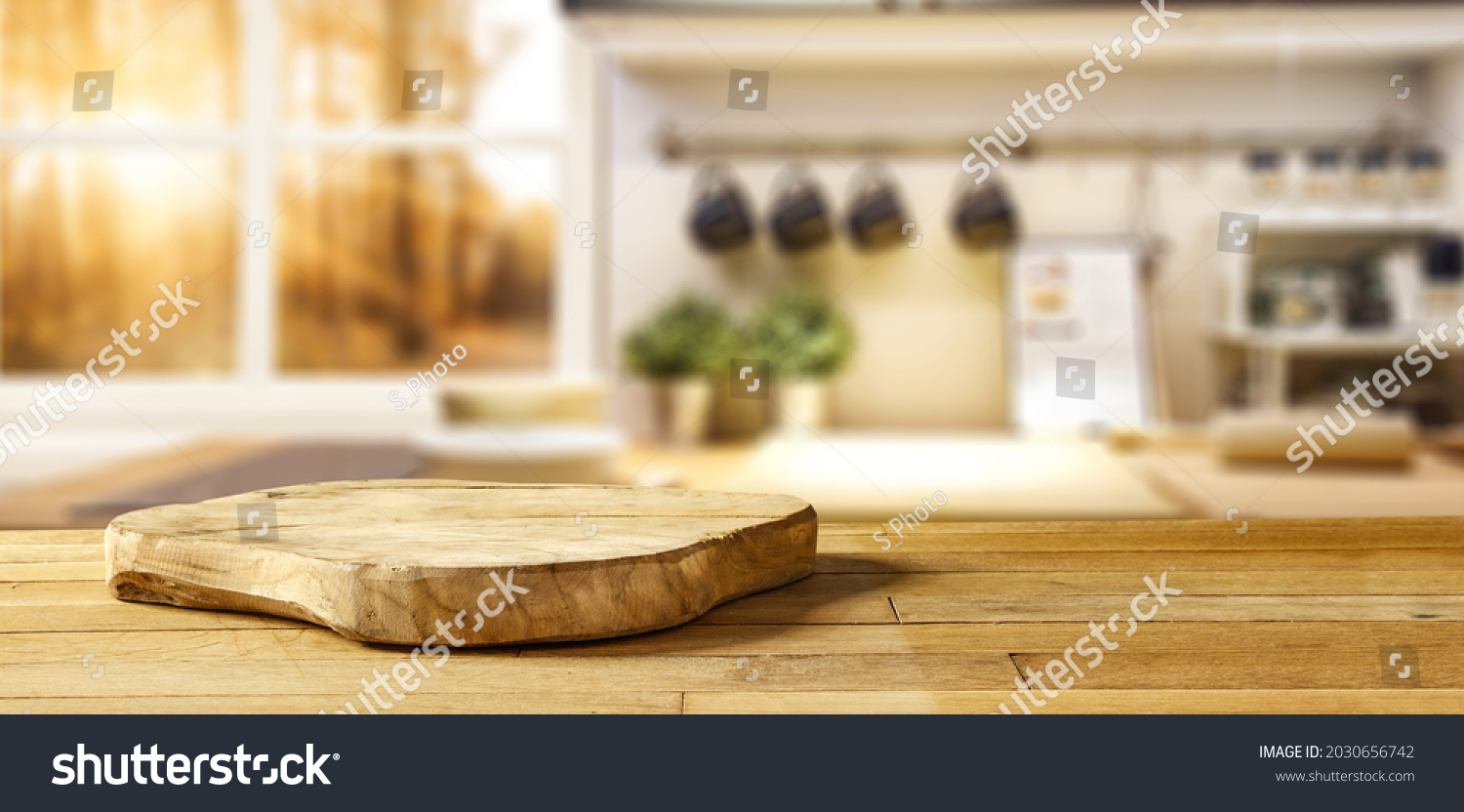 Wooden pedestal on table in kitchen interior and free space for your decoration 