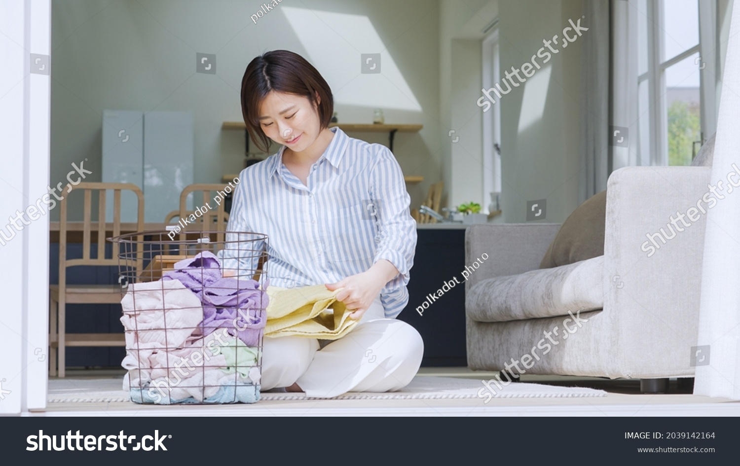 Asian woman folding a towel