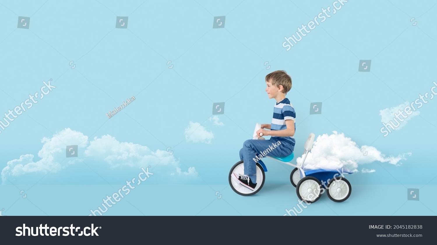 Child riding vintage tricycle. Childhood and imagination concept. Surreal freedom concept.