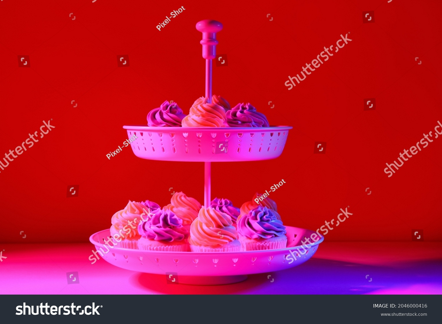 Dessert stand with tasty cupcakes on dark color background