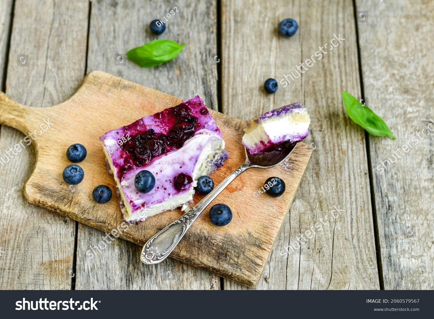 Homemade ketogenic  cheesecake with Blueberry   sauce .Healthy organic summer dessert  on wooden background