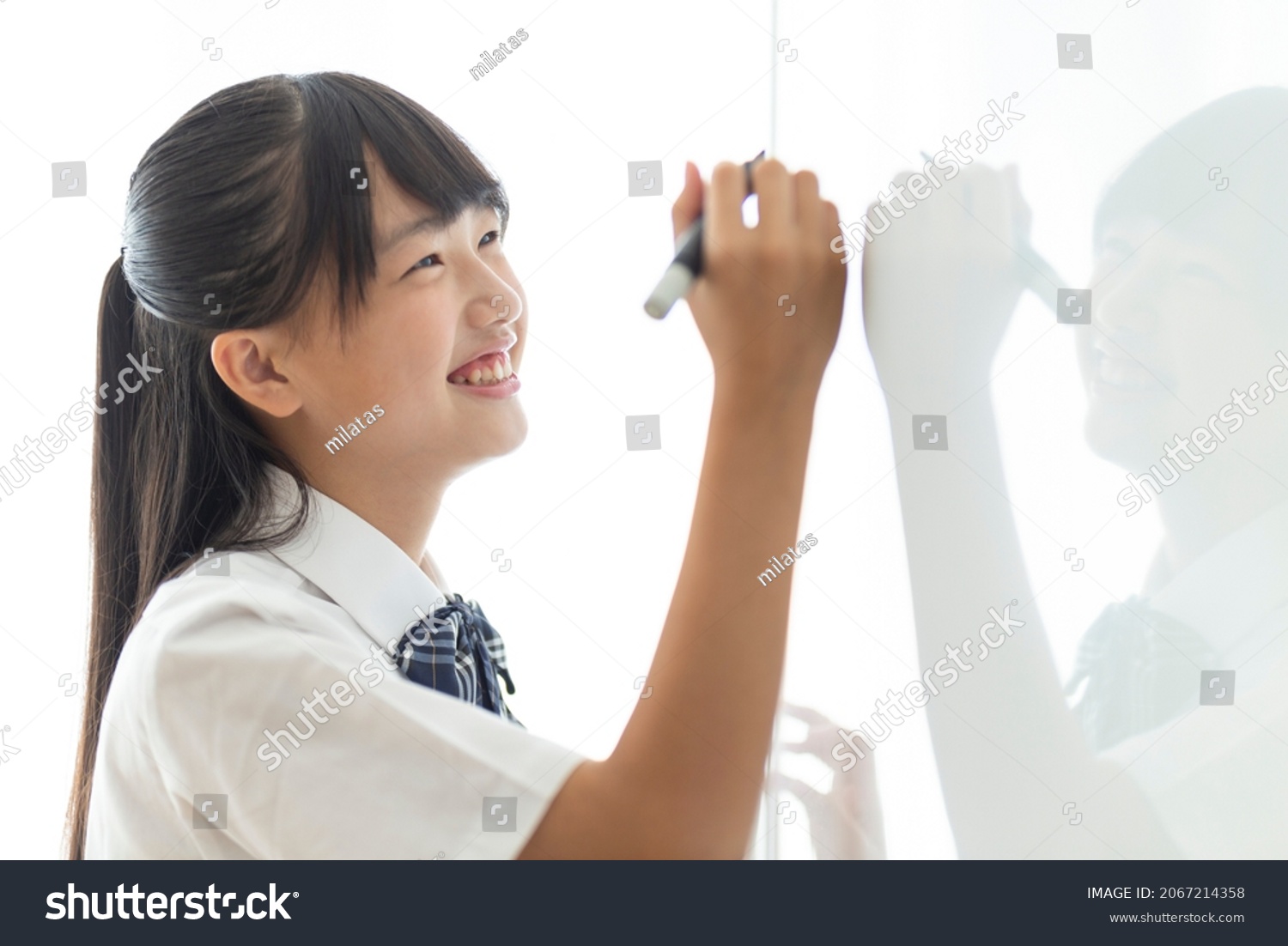 Junior high school students writing on the whiteboard