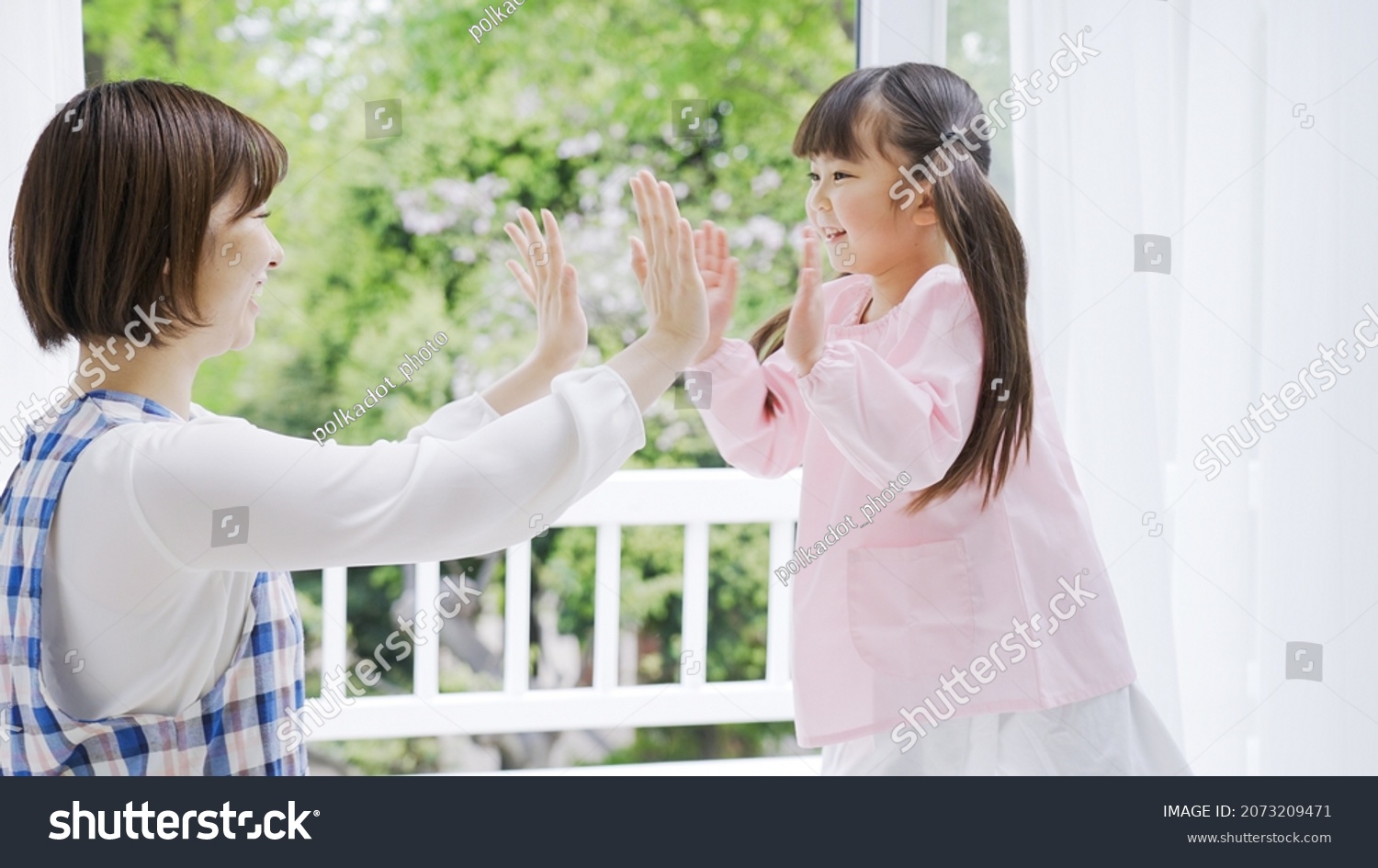 Asian nursery teacher and child