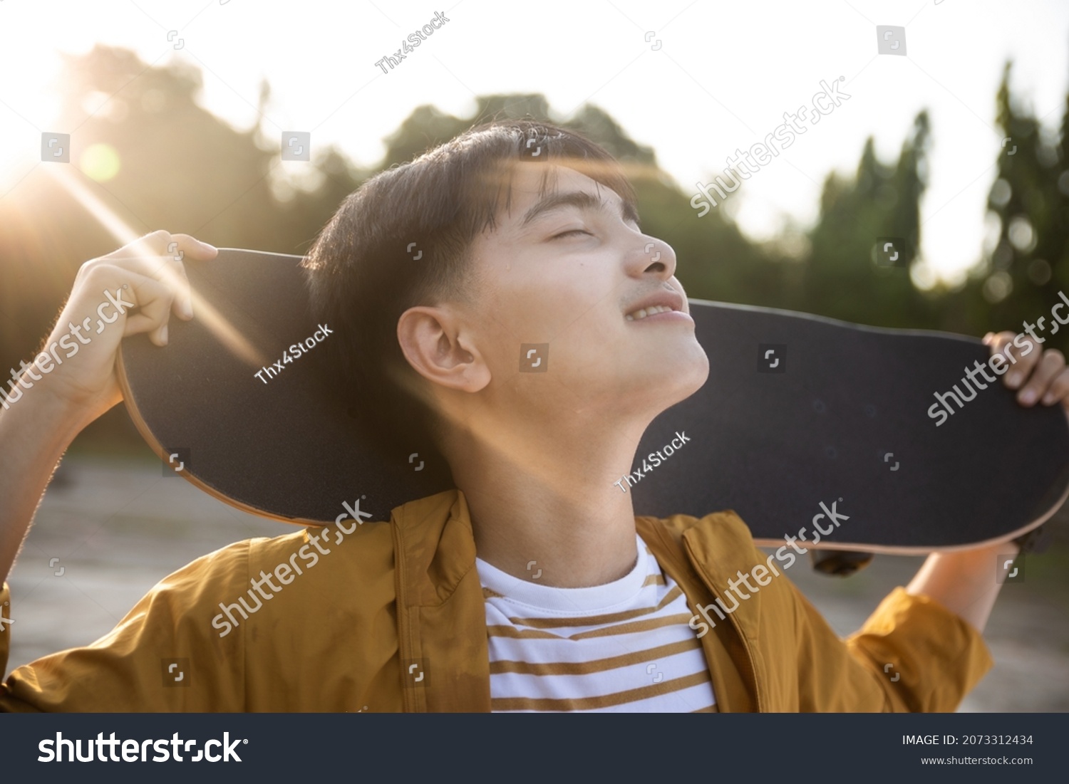 Teenager playing skateboard at cement ground  extreme sport and outdoor activity.
