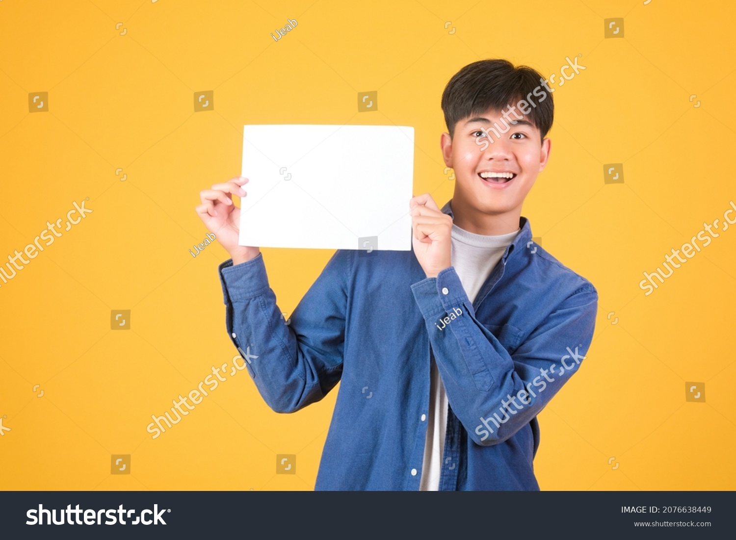 Male asian hand is holding blank paper board on white background
