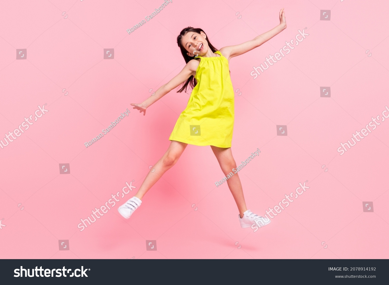 Full length photo of sweet shiny school girl wear yellow dress dark eyewear jumping high isolated pink color background