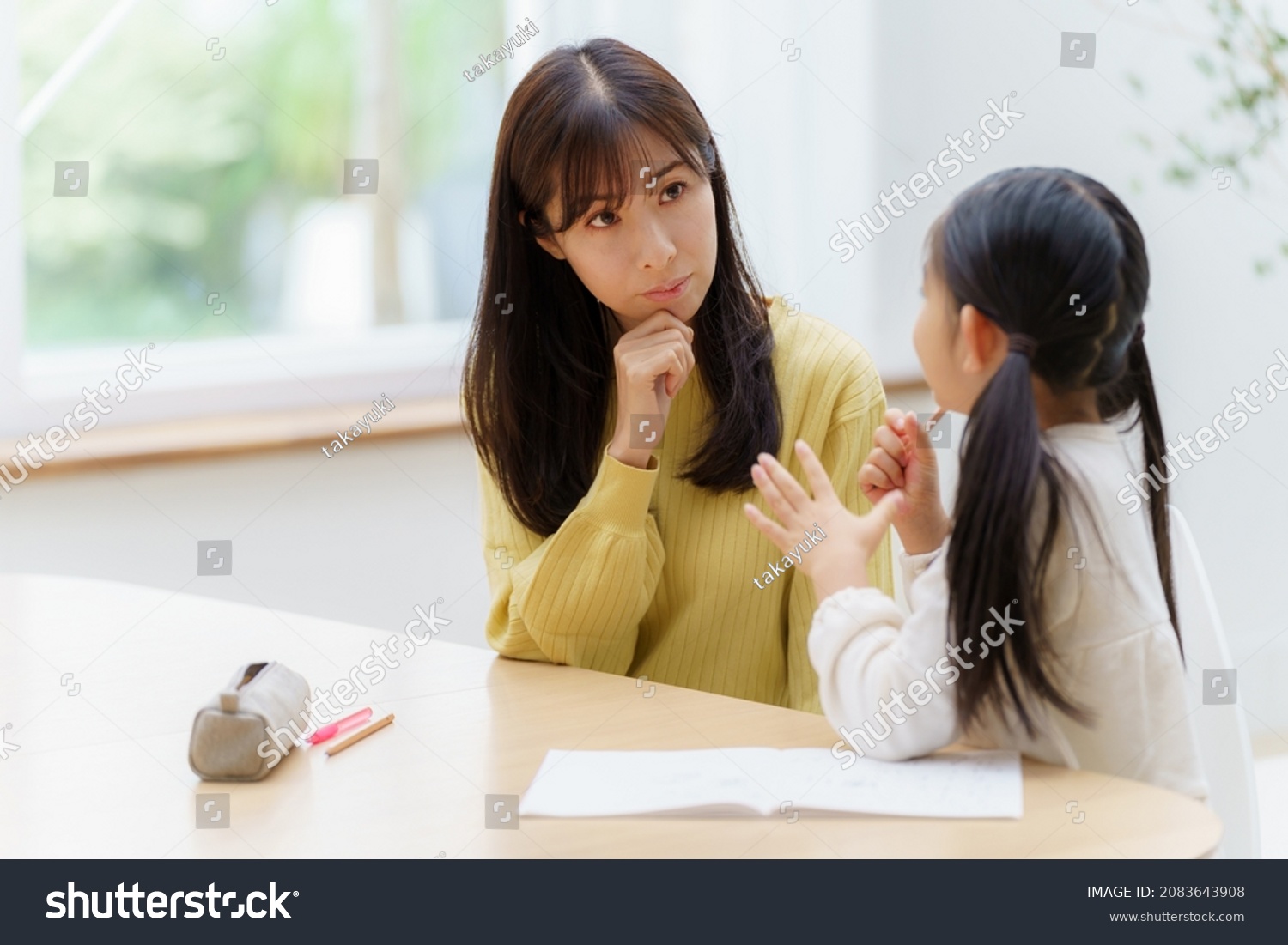 young asian woman studying with mother