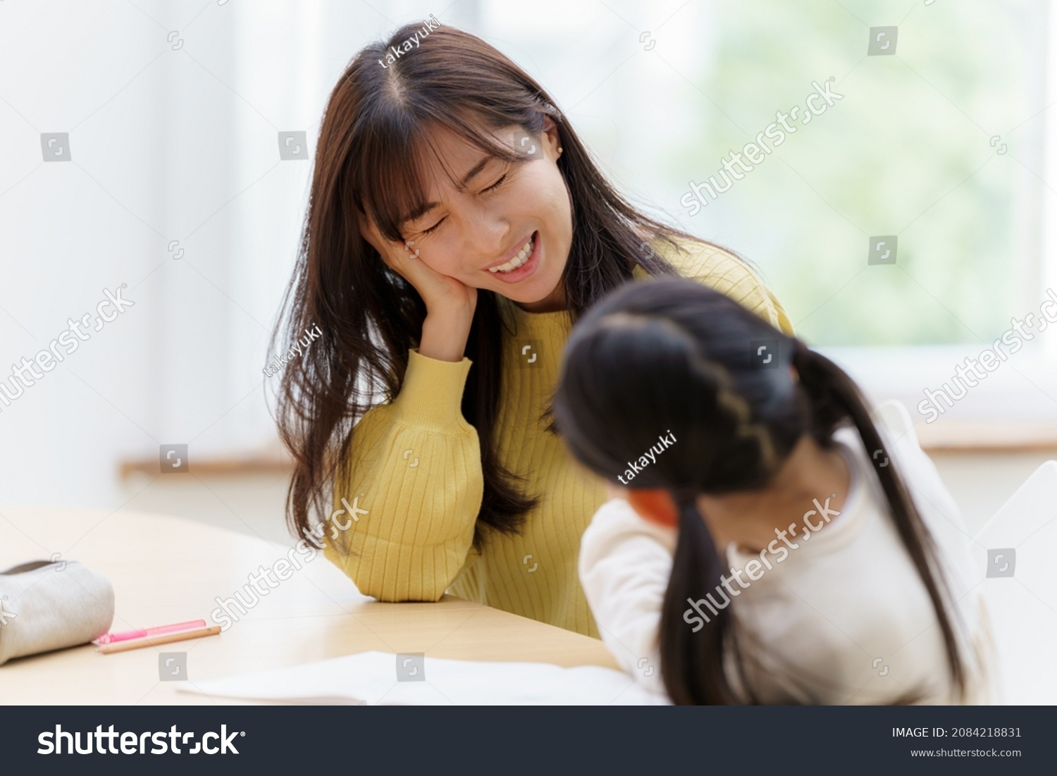 young asian woman studying with mother