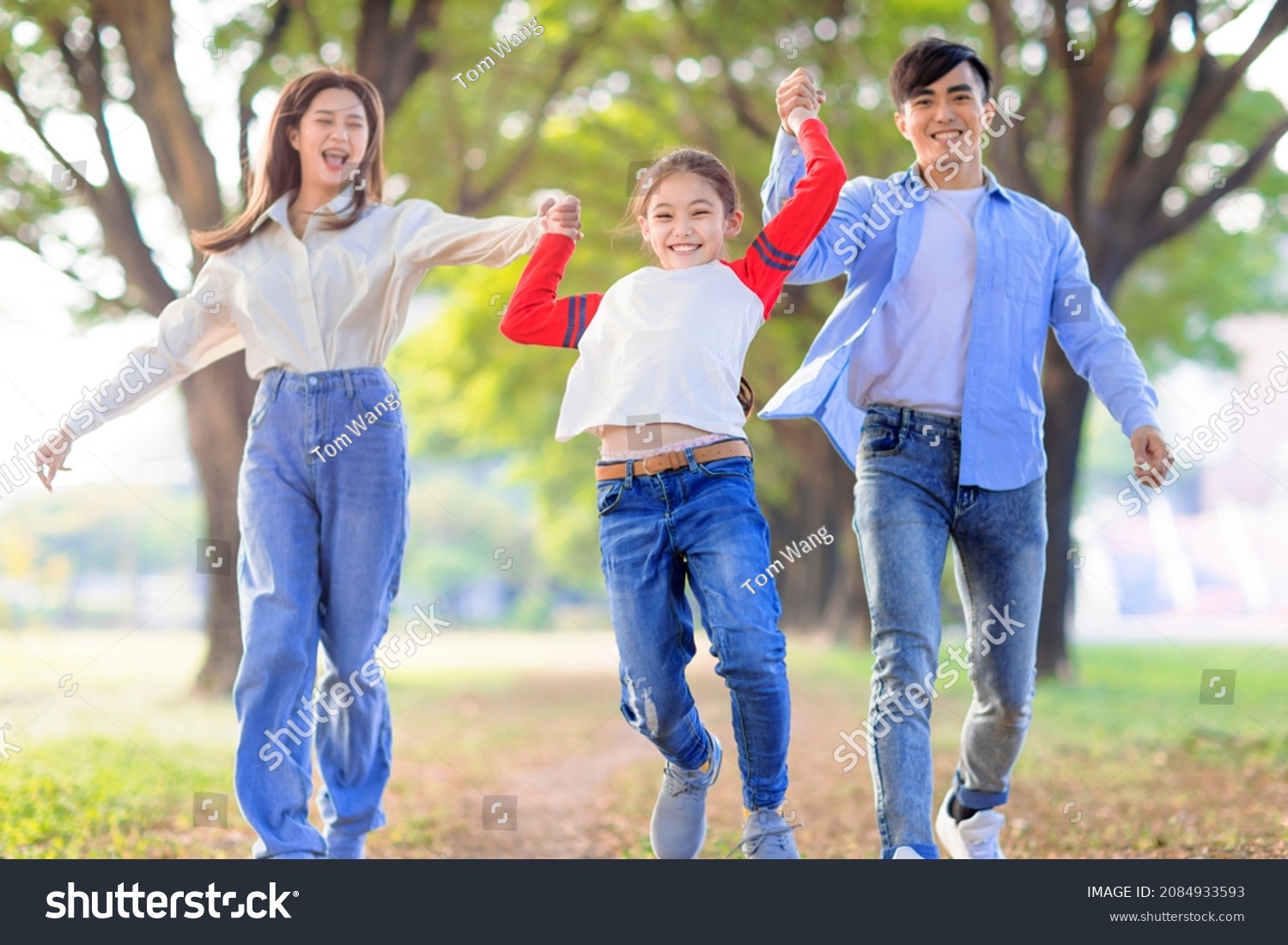 Happy Family jumping and playing together in the park
