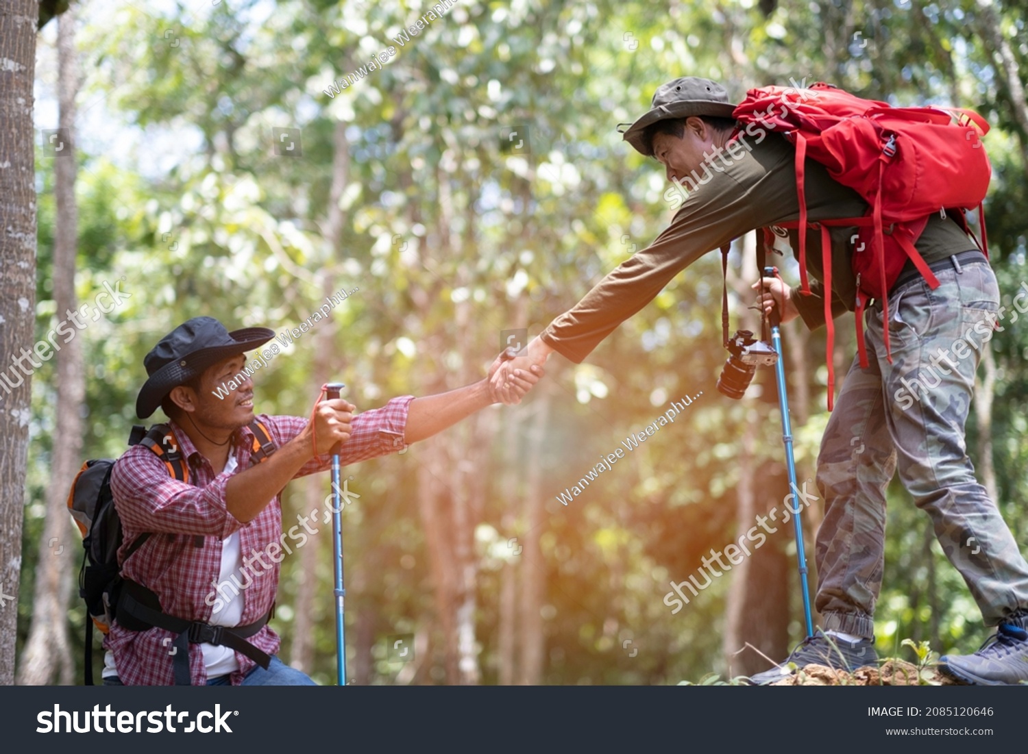 Fellow help his frient to climbing up to the top of hill with happiness friendship between hilking journey concept.