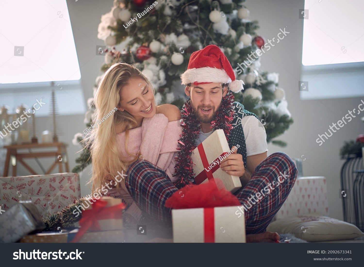 Happy caucasian couple exchangingXmas gifts on a Xmas morning