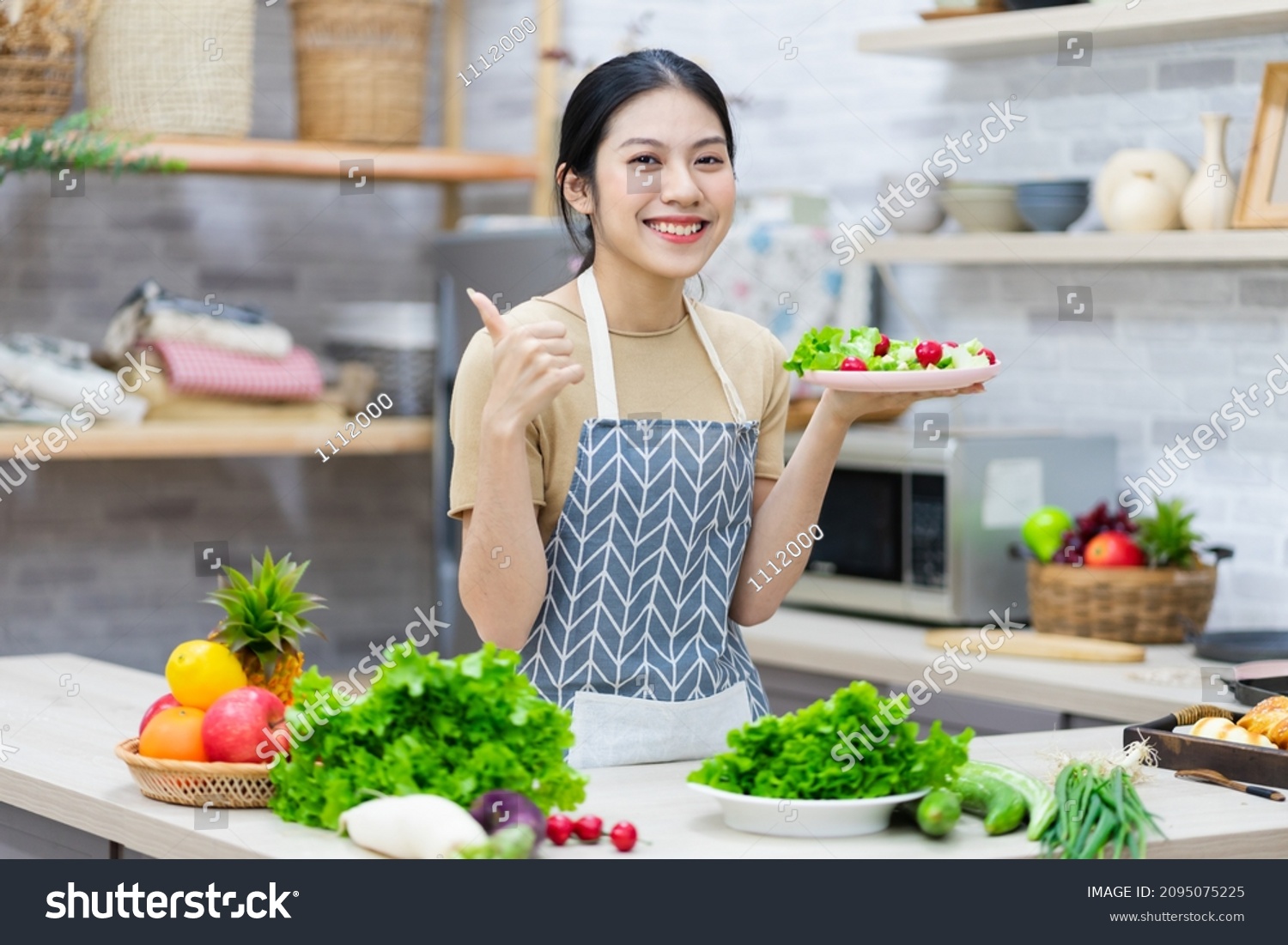 image of asian woman preparing salad in the kitchen