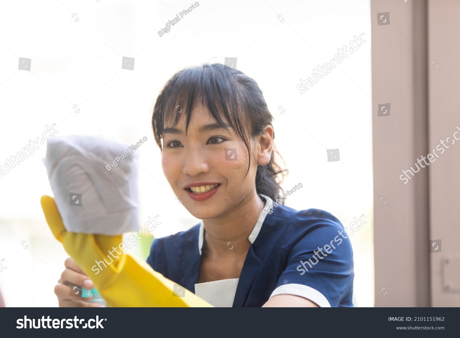 Housekeeper or Maid cleaning hotel room. Asian woman worker working in hotel and resort.