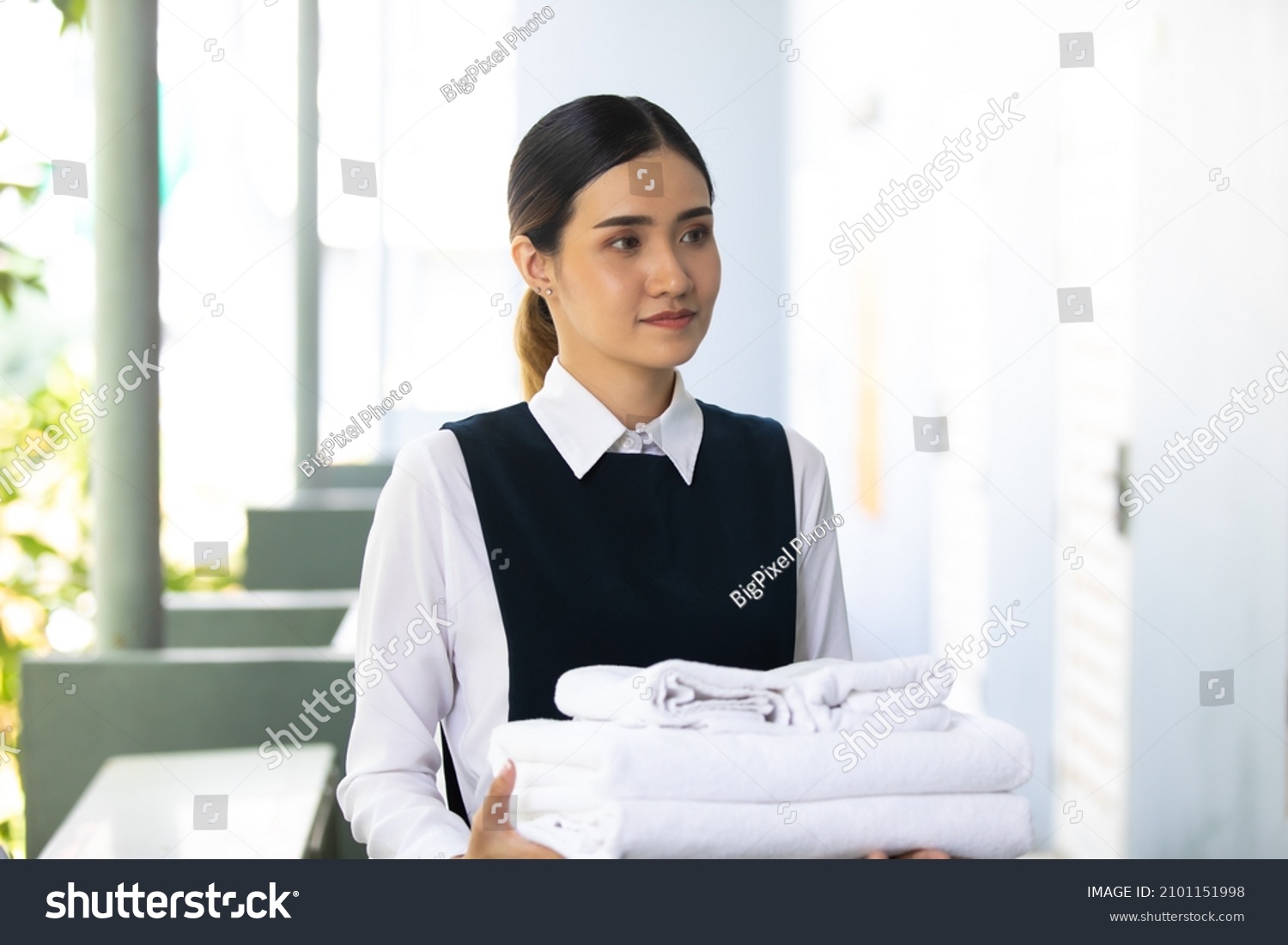 Housekeeper or Maid cleaning hotel room. Asian woman worker working in hotel and resort.