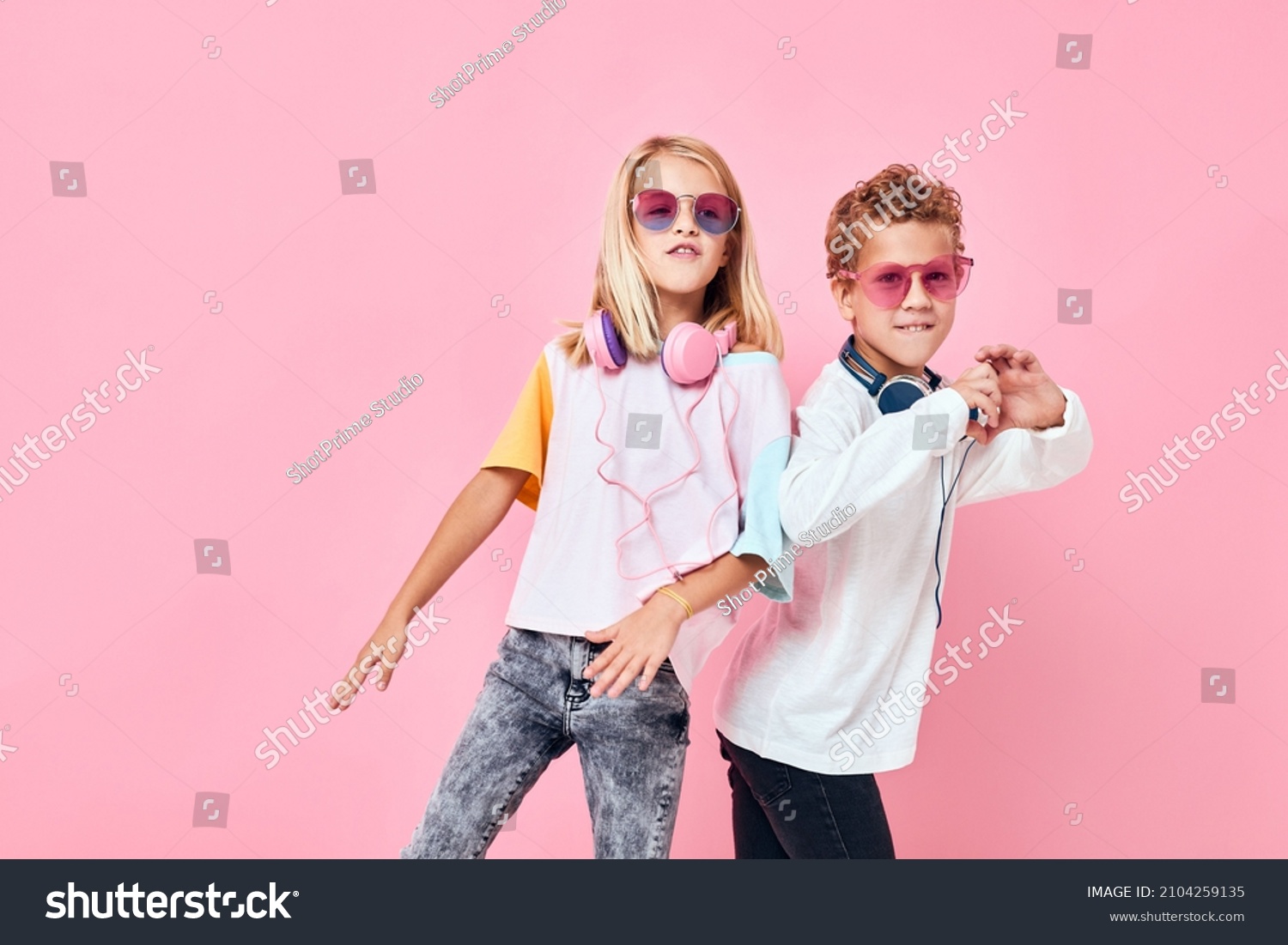 Portrait of a girl and a boy wearing headphones posing casual kids fashion