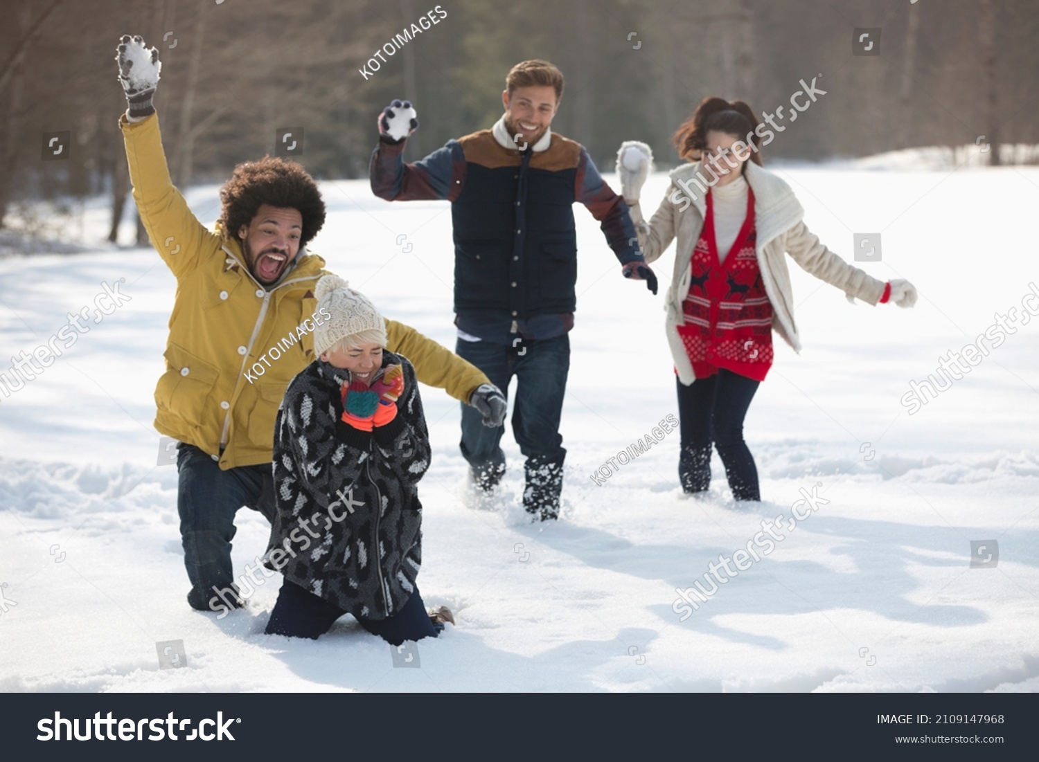 Happy Friends enjoying snowball fight