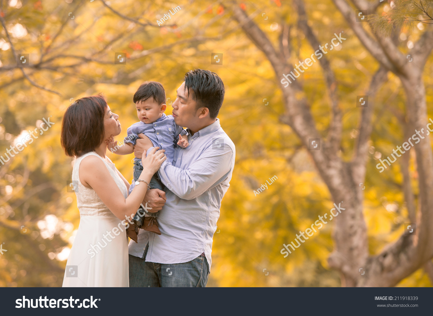 Asian young family having fun outdoors in autumn 