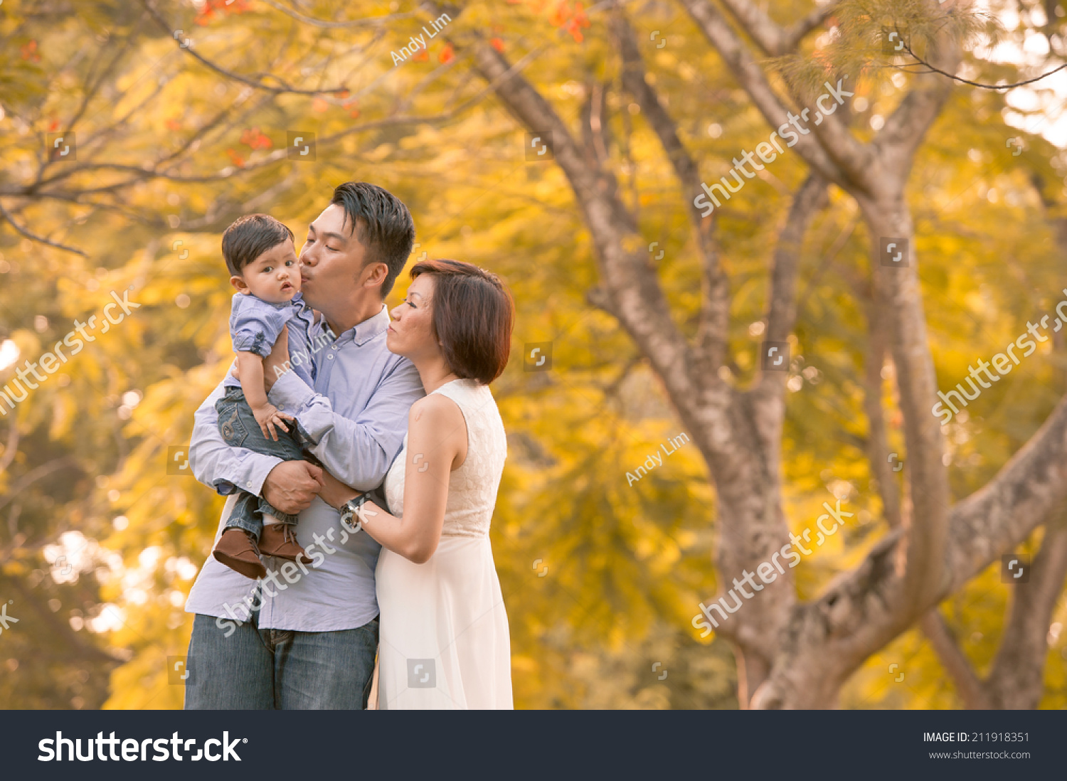 Asian young family having fun outdoors in autumn 