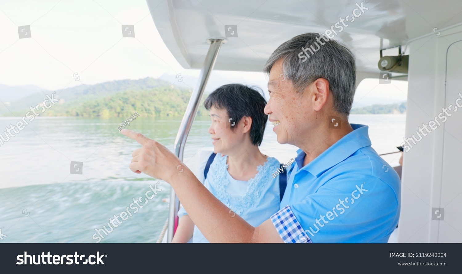 Authentic shot of asian elderly couple have fun on boat