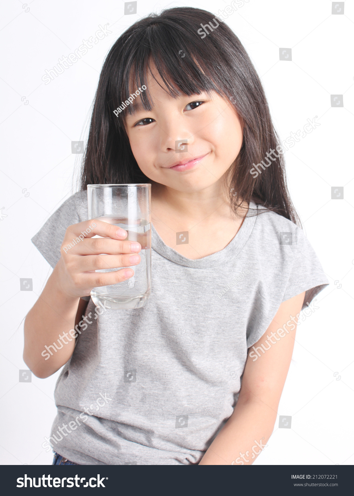 Young little girl drinking water.