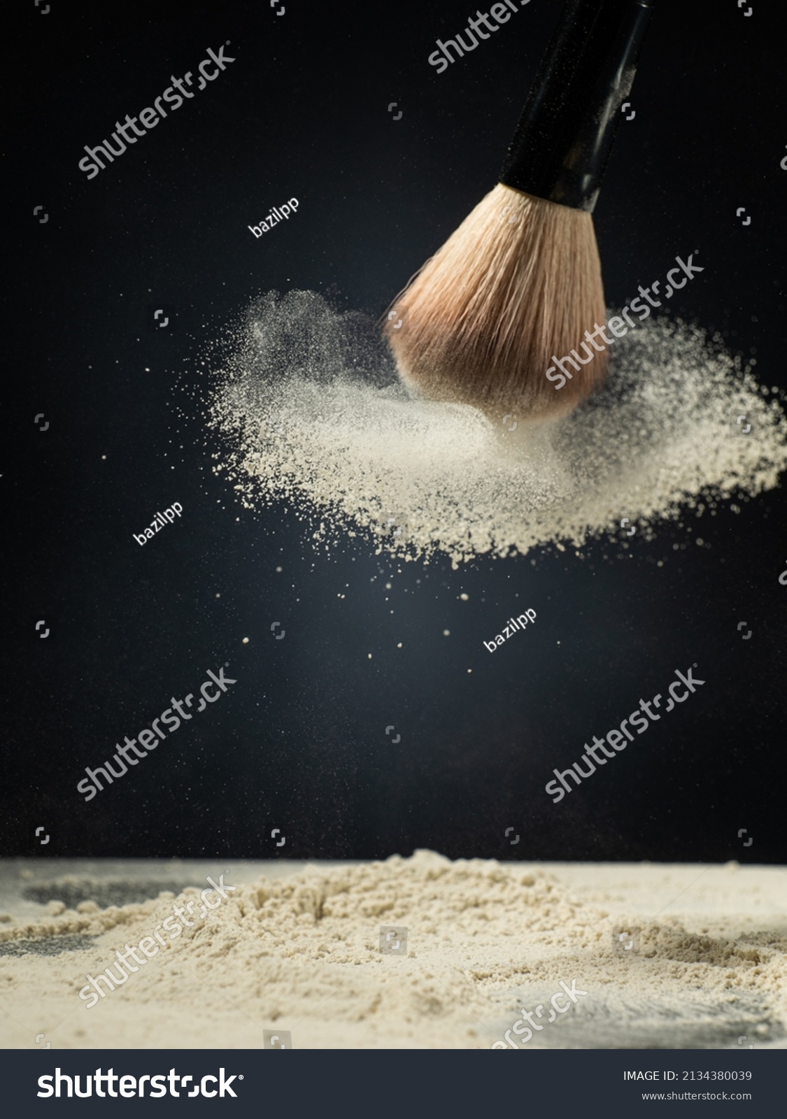 cosmetic brush and spray powder powder on a dark background