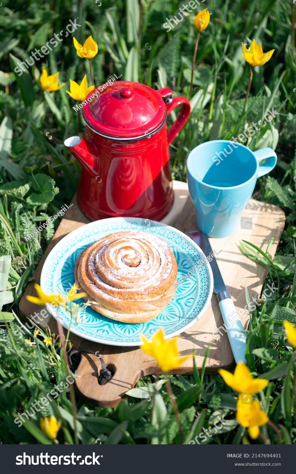spring picnic in the meadow. still life - basket on the background beautiful wild yellow tulips. atmosphere and mood