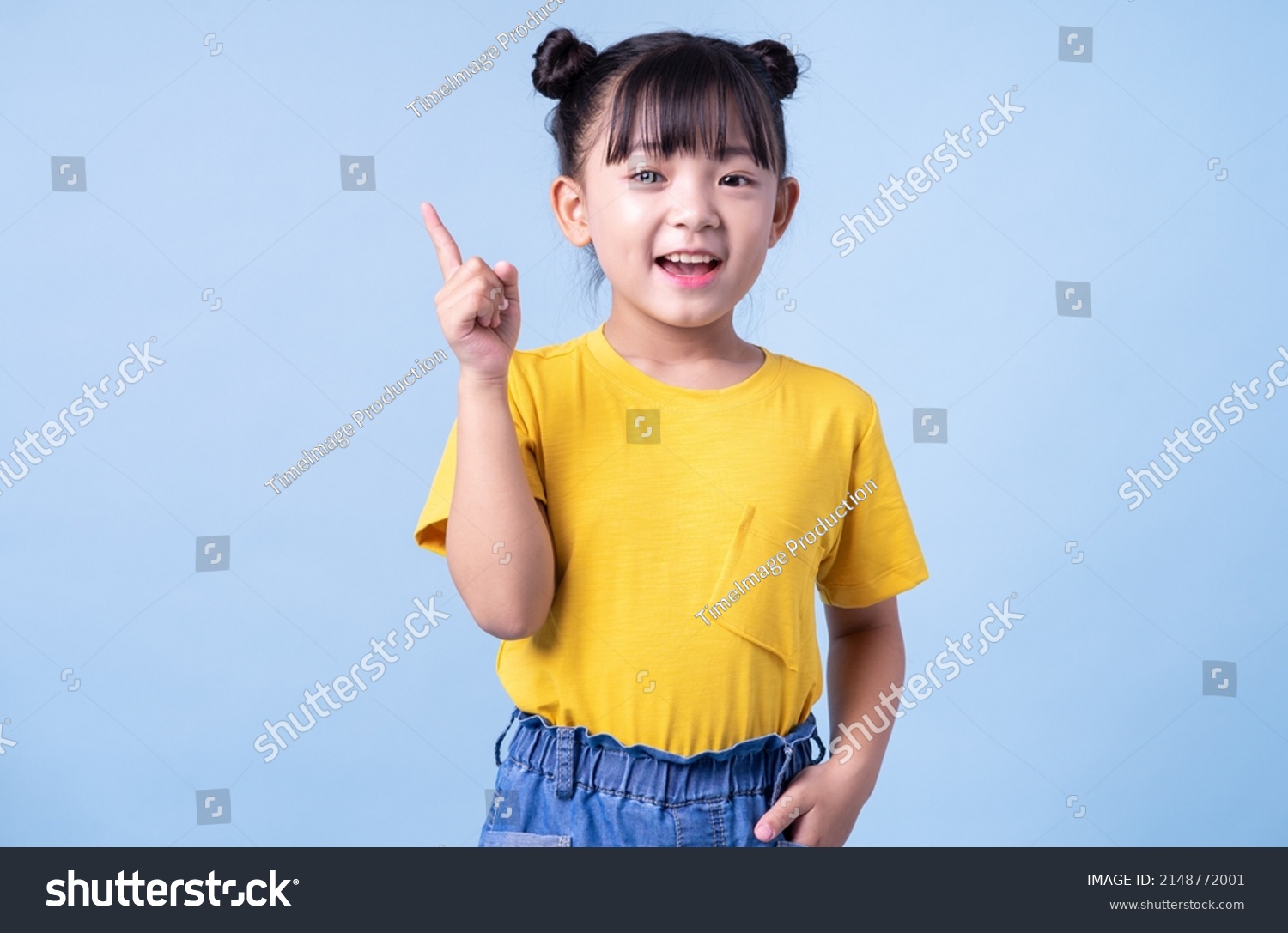 Image of Asian child posing on blue background
