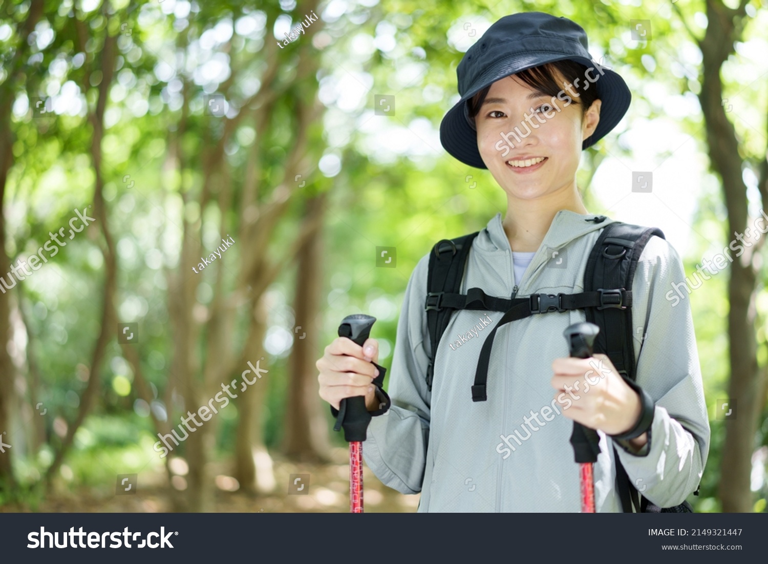 portrait of young asian woman walking in a forest