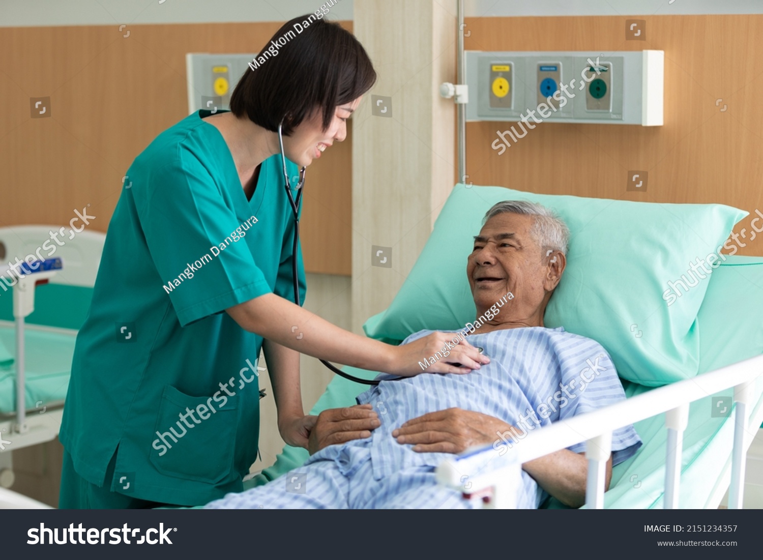 doctor using stethoscope and examining to elderly patient at waiting room in hospital 