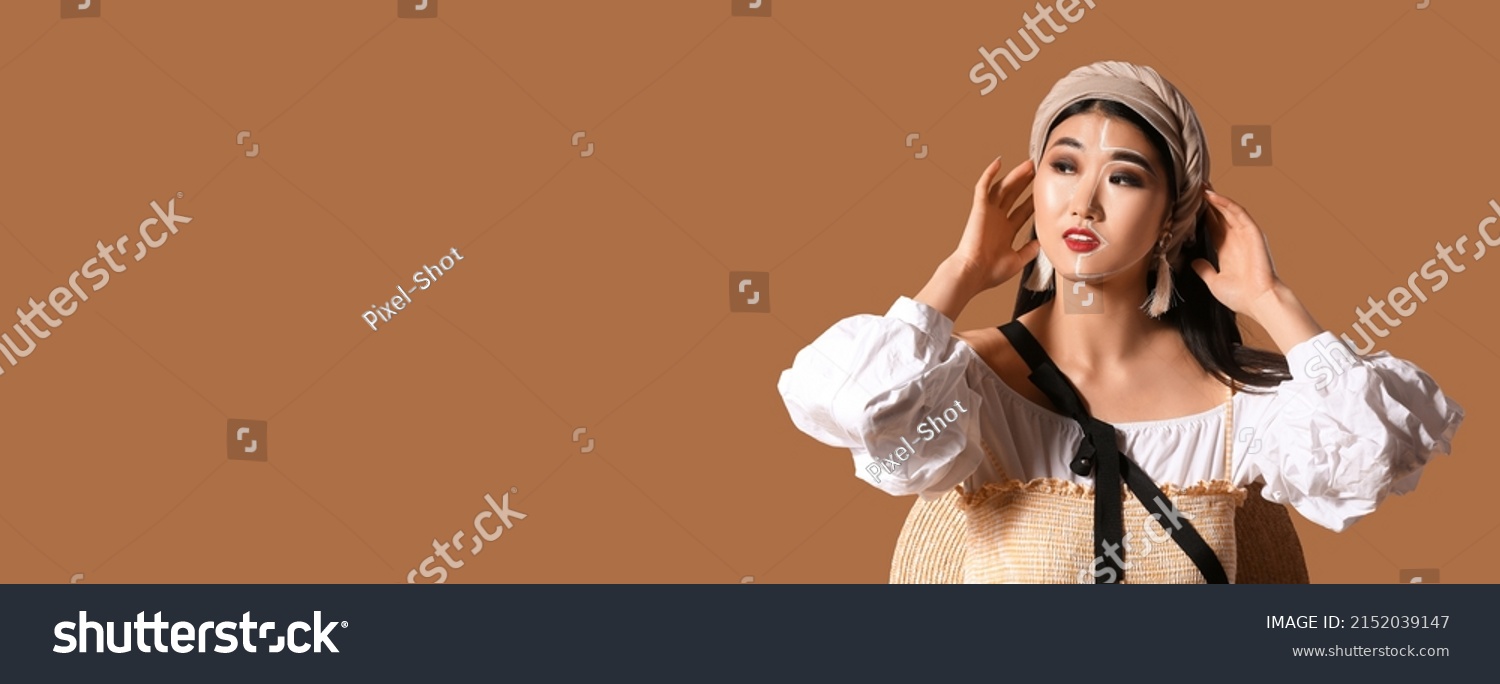 Portrait of stylish Asian woman on beige background with space for text