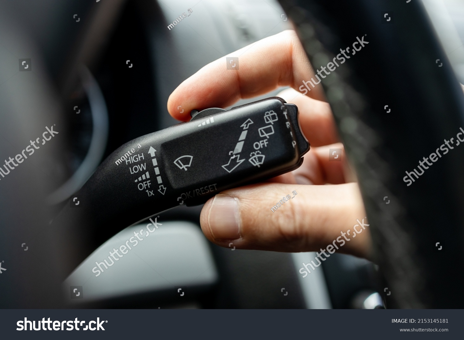 male person adjusting car wipers speed. car wiper switch handle macro