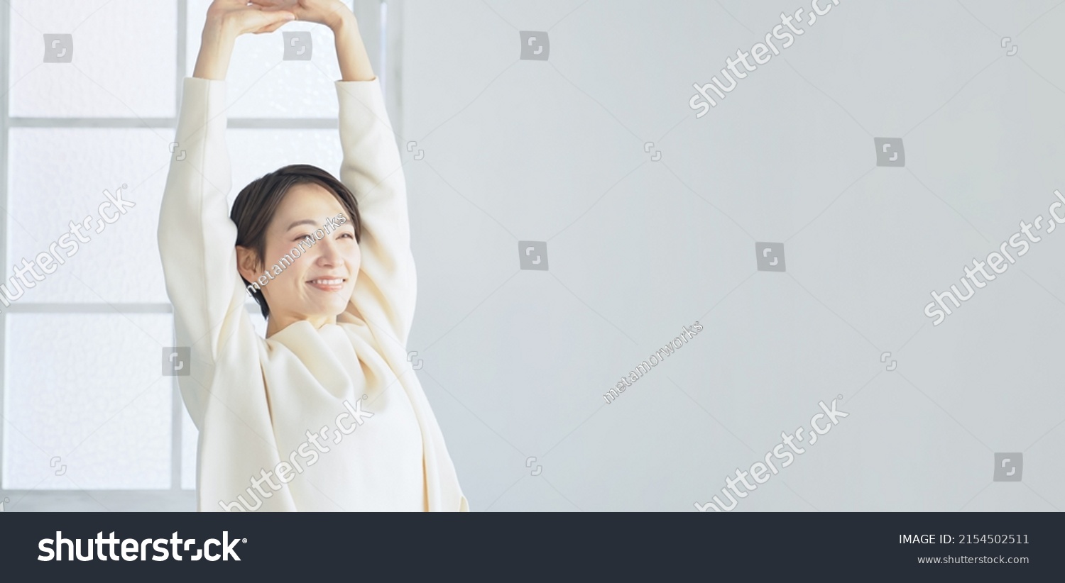 Middle aged Asian woman relaxing in the room.