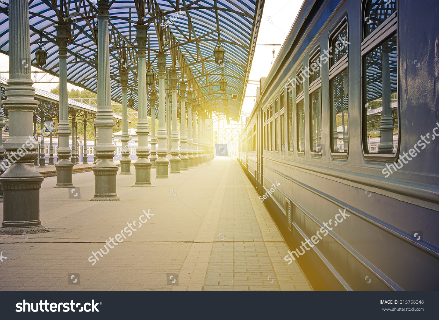Trains stand at the station at sunrise time.