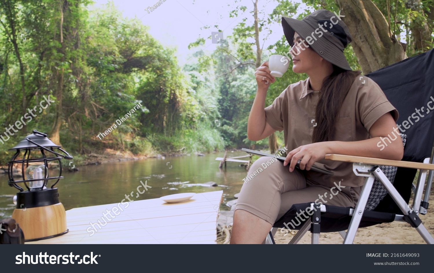 Asian woman travel and camping alone. Businesswoman online working and relaxing during journey outdoor activity.