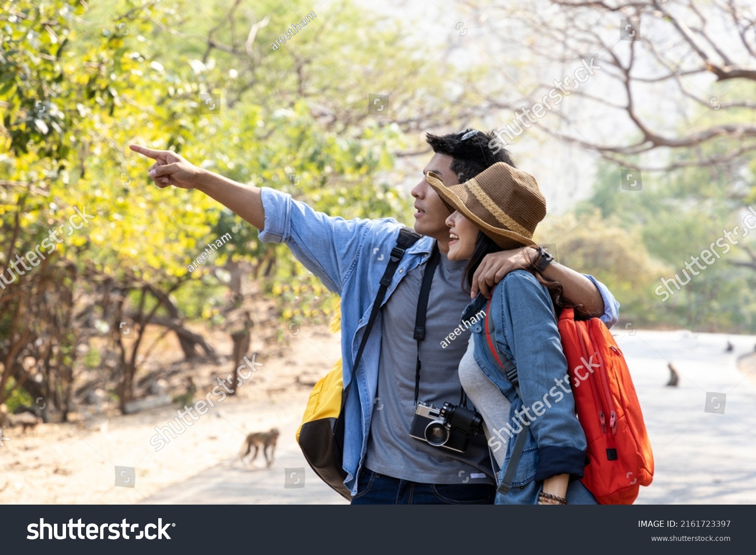 Asian young couple hiking in forest during summer