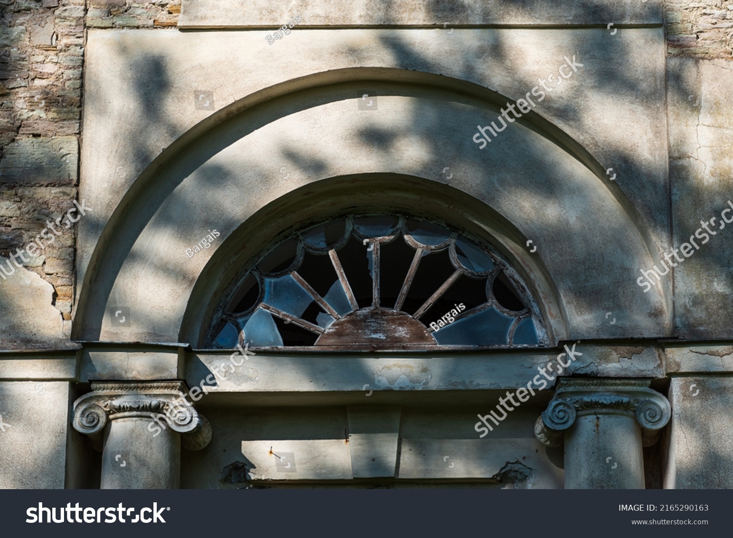 Ruins of Saliena lutheran church  Latvia. Beautiful arched window with broken glass.