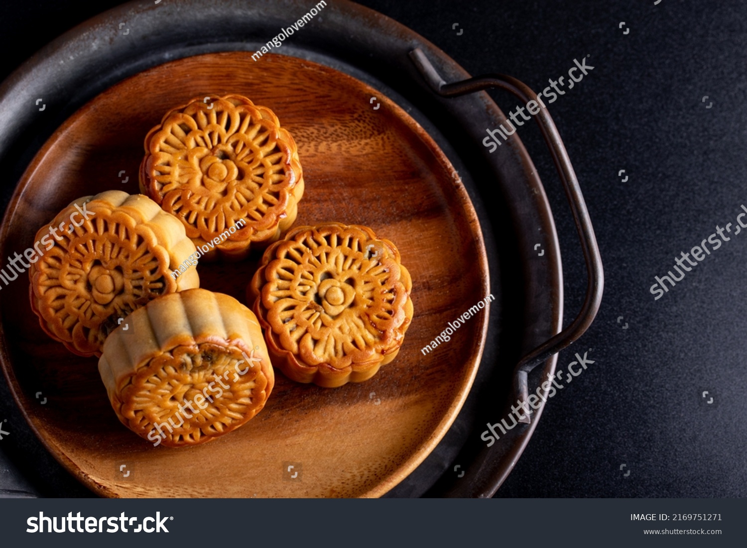 Mooncakes in a vintage tray Chinese festive snacks on black background