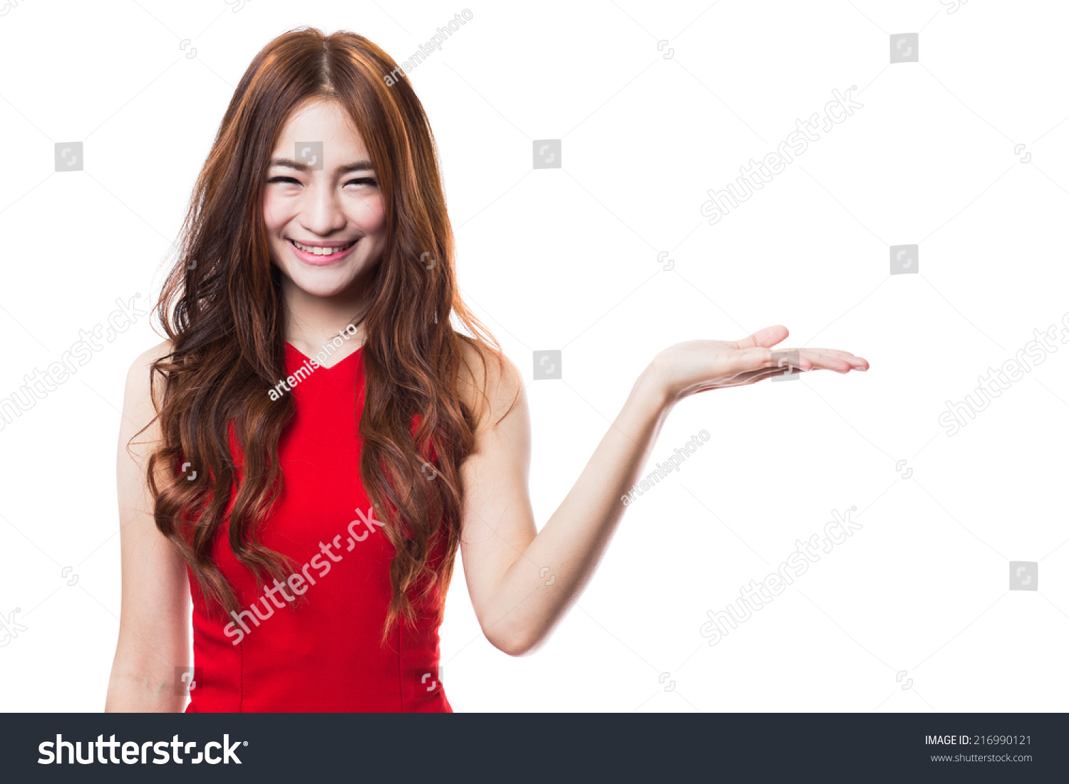 Beautiful young woman in red dress presenting with  open hand palm on white background